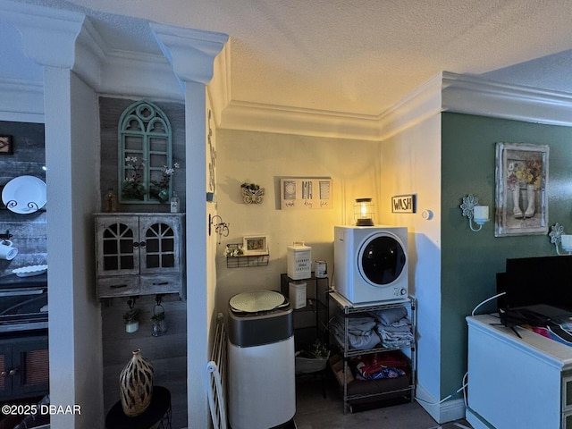 laundry room with baseboards, a textured ceiling, and ornamental molding