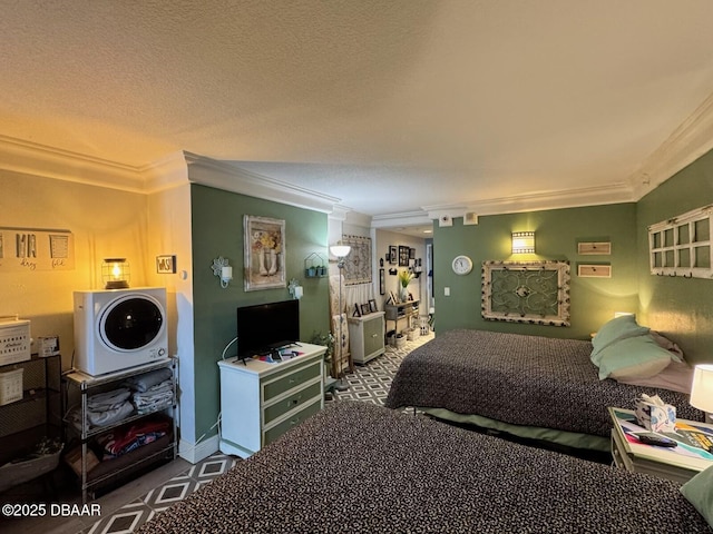 bedroom with crown molding, baseboards, and a textured ceiling