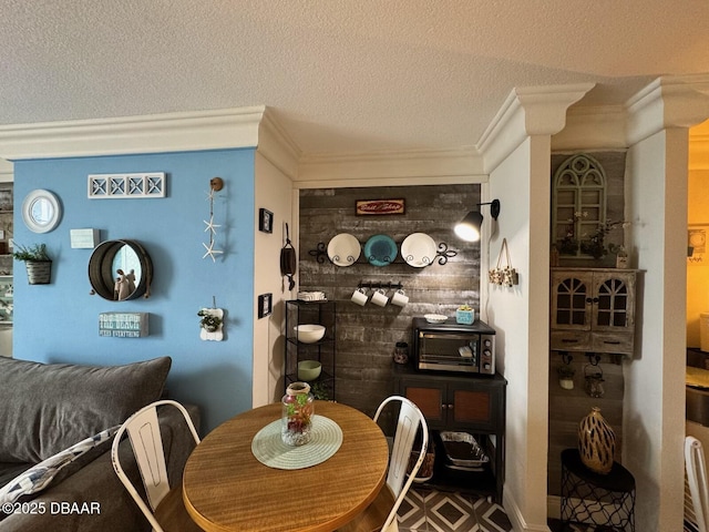 dining area with crown molding, a toaster, and a textured ceiling