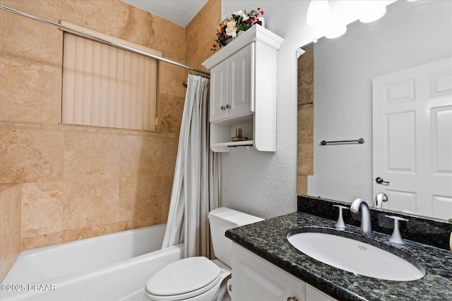 full bath with toilet, a textured wall, shower / bath combo, and vanity