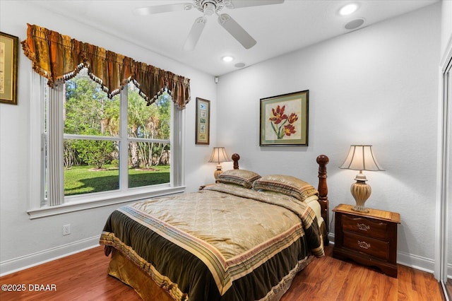 bedroom featuring ceiling fan, recessed lighting, wood finished floors, and baseboards