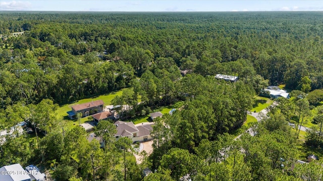 drone / aerial view featuring a residential view and a view of trees