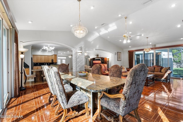 dining area featuring lofted ceiling, visible vents, arched walkways, and recessed lighting