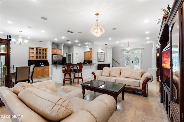 living room with ornamental molding, recessed lighting, visible vents, and a notable chandelier