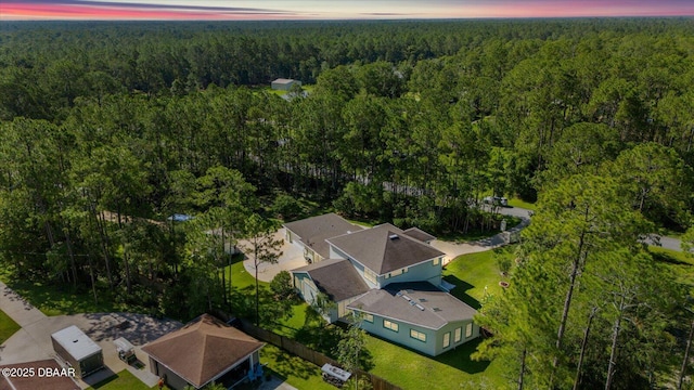 drone / aerial view featuring a wooded view