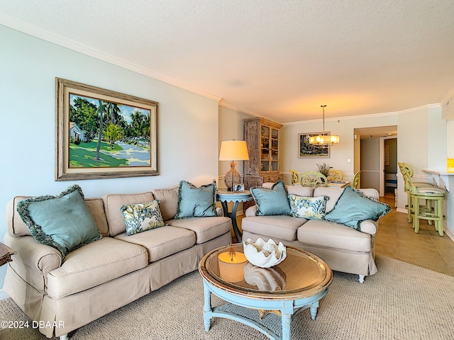 tiled living room featuring ornamental molding, a textured ceiling, and a notable chandelier