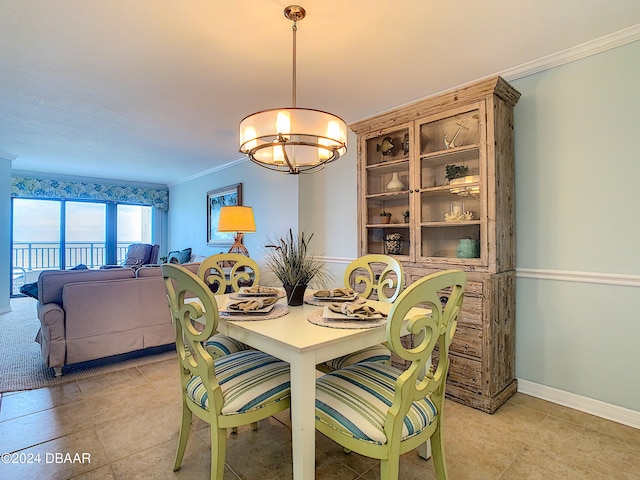 dining room featuring light tile patterned flooring, a chandelier, and crown molding