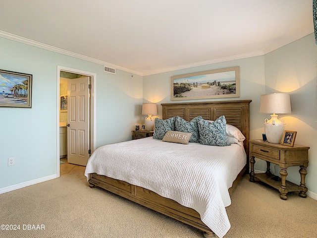 bedroom featuring ensuite bathroom, light carpet, and crown molding