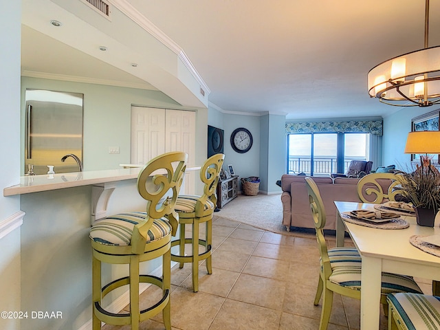 dining area featuring light tile patterned flooring, crown molding, and a notable chandelier