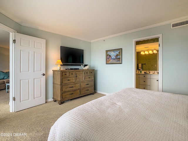 bedroom featuring ornamental molding, ensuite bath, and light carpet