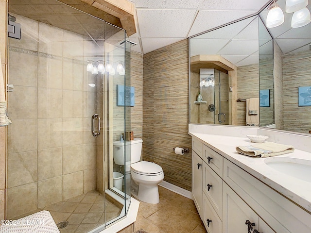 bathroom with walk in shower, tile patterned flooring, vanity, toilet, and tile walls