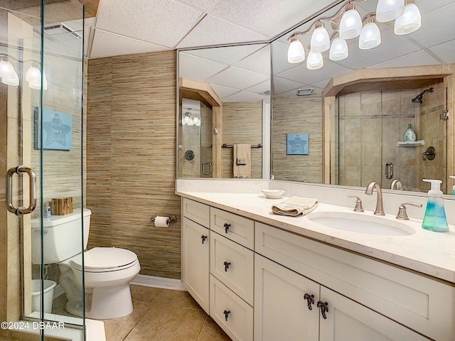 bathroom featuring tile patterned flooring, an enclosed shower, vanity, and toilet