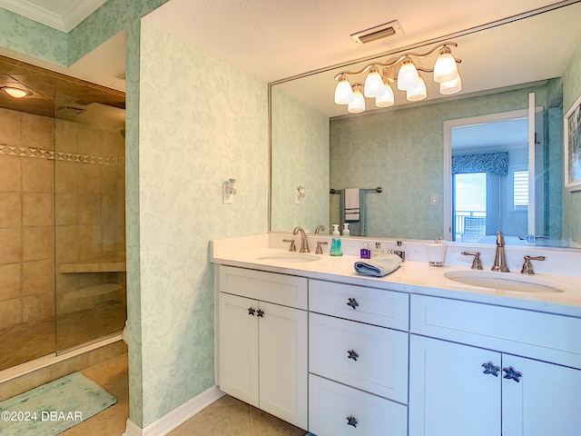 bathroom featuring vanity, tile patterned flooring, and a tile shower