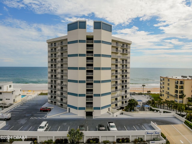 view of property featuring a water view and a view of the beach