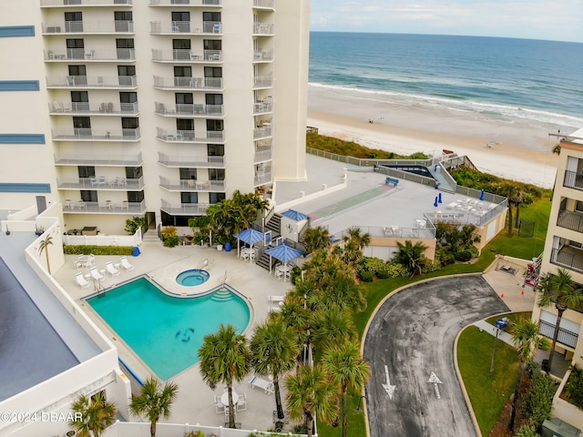 bird's eye view featuring a view of the beach and a water view