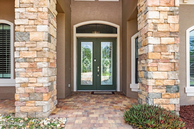 view of exterior entry featuring french doors