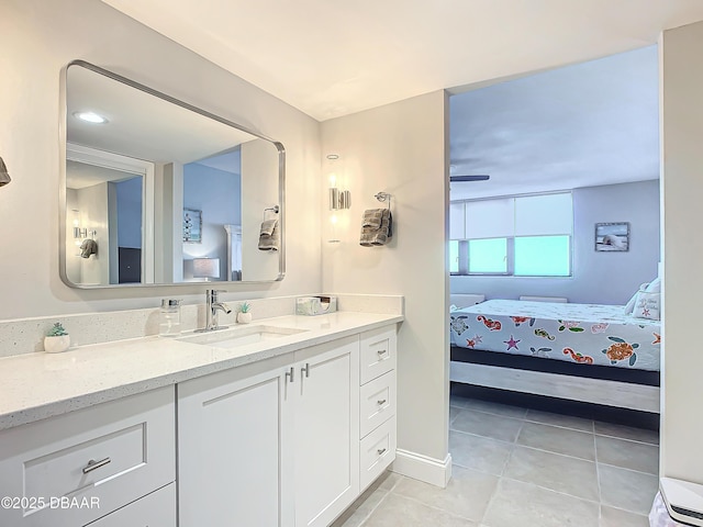 ensuite bathroom with tile patterned flooring, connected bathroom, and vanity