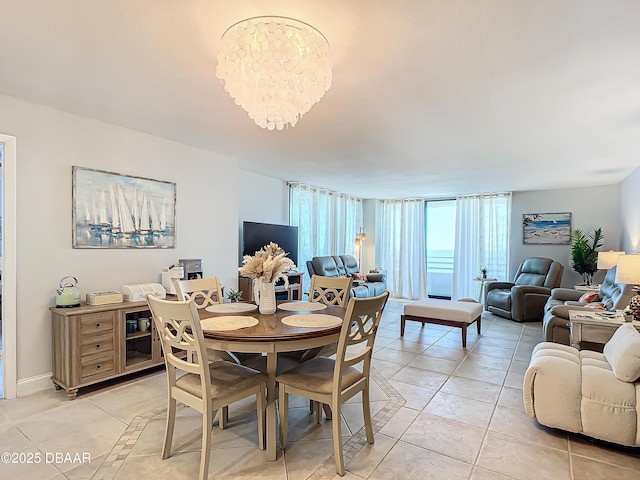 dining space featuring a chandelier and light tile patterned flooring