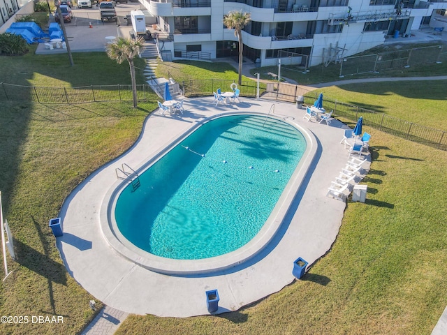 pool with a yard, a patio area, and fence