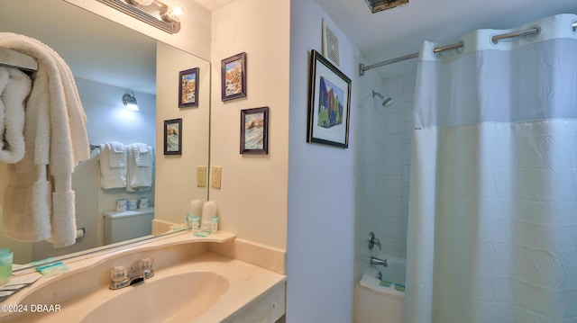 full bathroom with vanity, shower / bathtub combination with curtain, and toilet