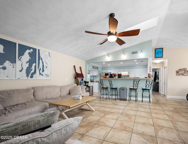 living room with vaulted ceiling, ceiling fan, and light tile patterned flooring