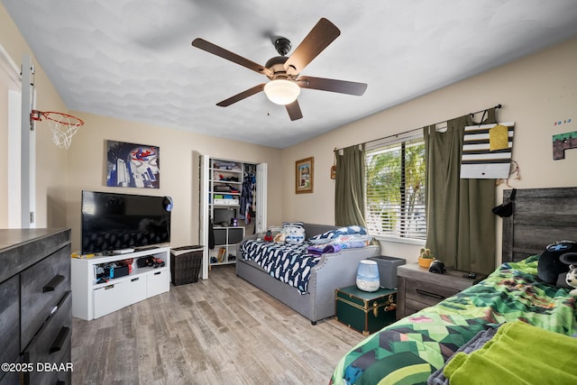 bedroom with ceiling fan and light wood-type flooring