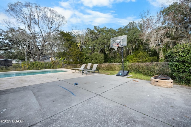 exterior space with a fenced in pool and a fire pit