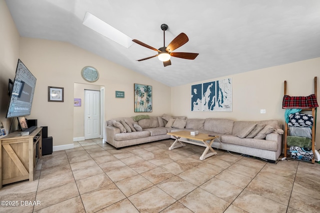 living room with lofted ceiling with skylight, ceiling fan, and light tile patterned flooring