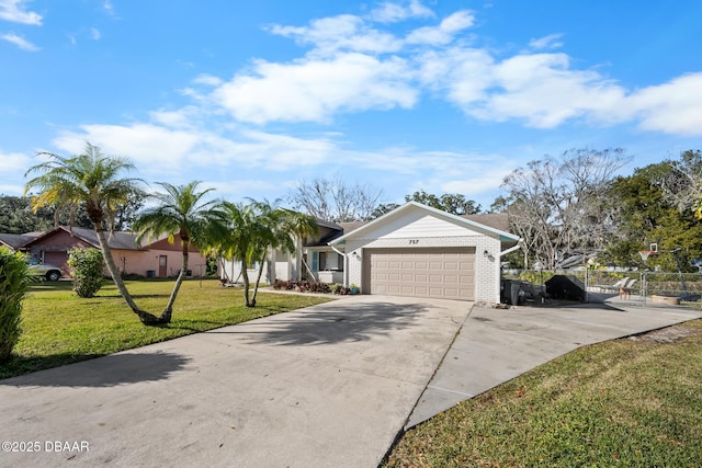 single story home featuring a garage and a front lawn