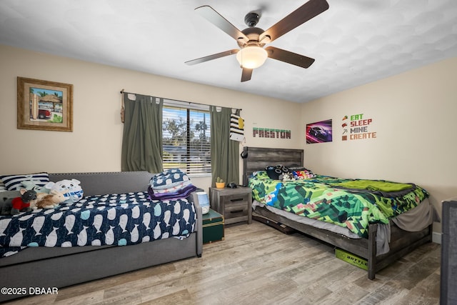 bedroom with hardwood / wood-style floors and ceiling fan