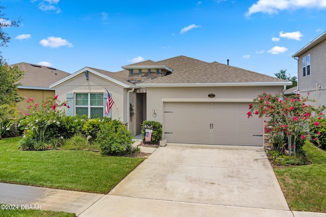 view of front of home with a garage and a front yard