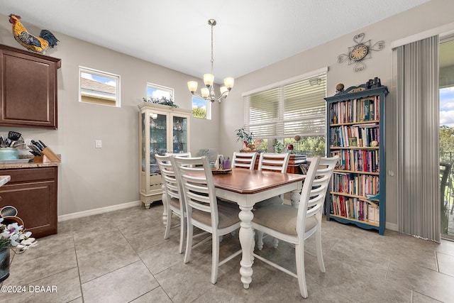 tiled dining area with a chandelier