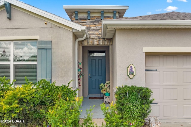 doorway to property with a garage