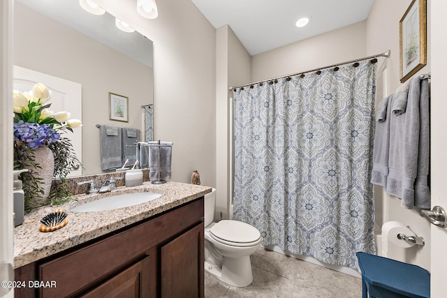 bathroom featuring toilet, vanity, and tile patterned floors