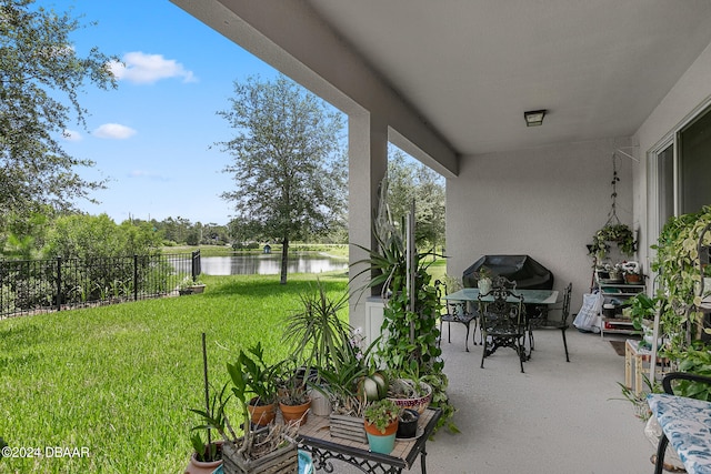 balcony with a water view and a patio