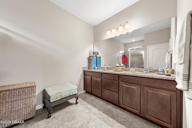 bathroom with vanity and a shower with door