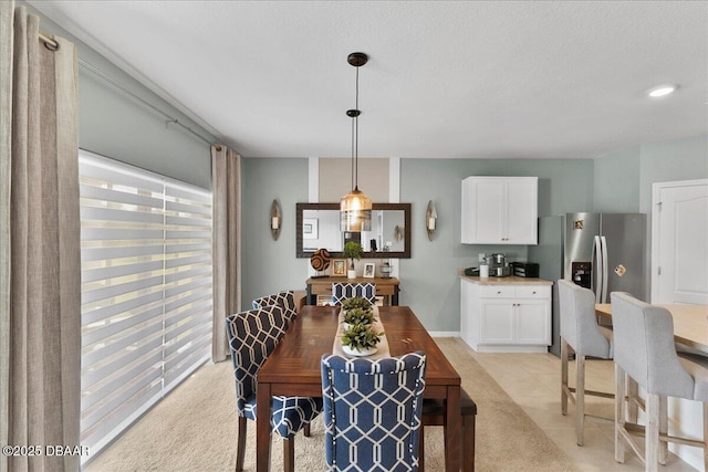 2714 Neverland Dr, New Smyrna Beach, FL 32168 - dining space featuring light carpet and a textured ceiling