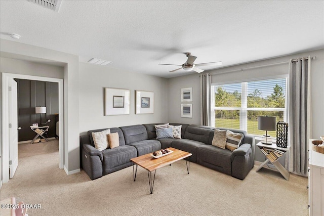 2714 Neverland Dr, New Smyrna Beach, FL 32168 - living area featuring light carpet, a ceiling fan, and a textured ceiling