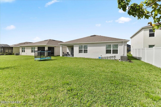 2714 Neverland Dr, New Smyrna Beach, FL 32168 - rear view of property featuring a trampoline and stucco siding