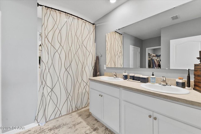 2714 Neverland Dr, New Smyrna Beach, FL 32168 - full bathroom with double vanity and a spacious closet