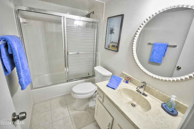 4175 S Atlantic Ave Unit 1240, New Smyrna Beach, FL 32169 - full bathroom featuring toilet, vanity, tile patterned flooring, and shower / bath combination with glass door