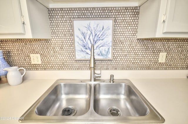 4175 S Atlantic Ave Unit 1240, New Smyrna Beach, FL 32169 - details with white cabinetry, sink, and backsplash