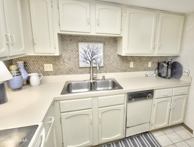 kitchen featuring dishwasher, range, sink, light tile patterned floors, and backsplash