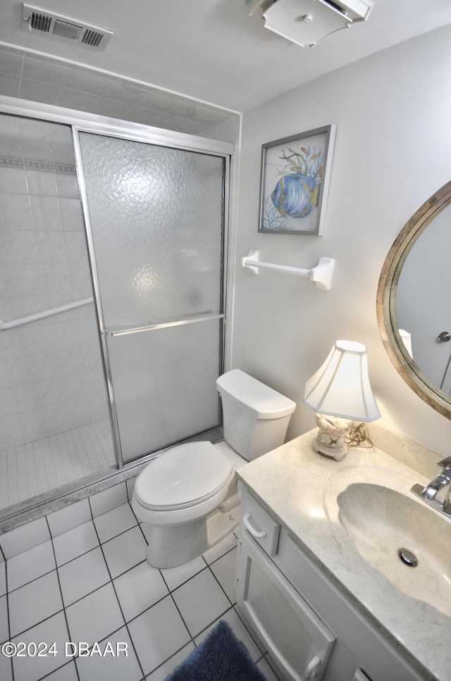 4175 S Atlantic Ave Unit 1240, New Smyrna Beach, FL 32169 - bathroom featuring vanity, walk in shower, tile patterned flooring, and toilet