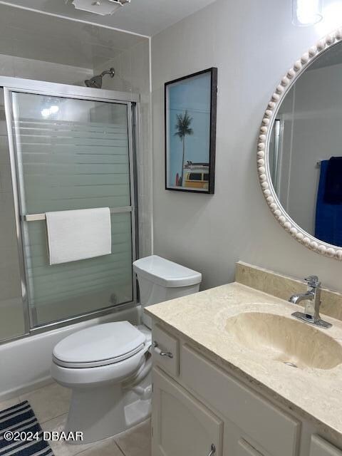 4175 S Atlantic Ave Unit 1240, New Smyrna Beach, FL 32169 - full bathroom with toilet, vanity, tile patterned floors, and shower / bath combination with glass door