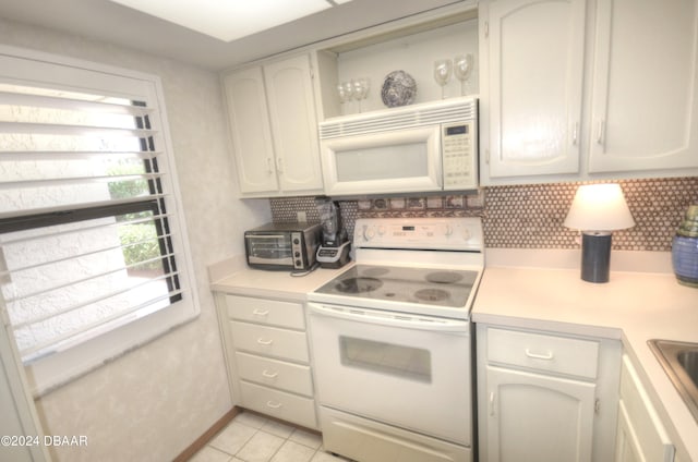 4175 S Atlantic Ave Unit 1240, New Smyrna Beach, FL 32169 - kitchen with tasteful backsplash, light tile patterned floors, and white appliances