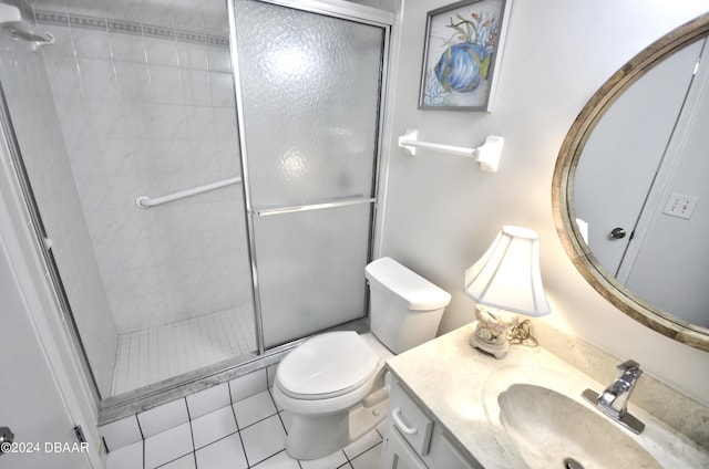 4175 S Atlantic Ave Unit 1240, New Smyrna Beach, FL 32169 - bathroom featuring walk in shower, vanity, toilet, and tile patterned flooring