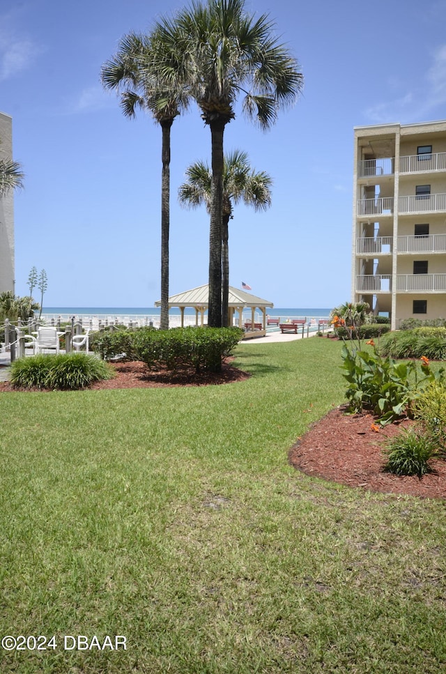 4175 S Atlantic Ave Unit 1240, New Smyrna Beach, FL 32169 - surrounding community with a beach view, a water view, and a lawn