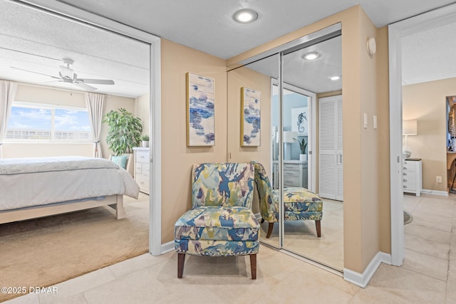 carpeted bedroom with ceiling fan and a closet