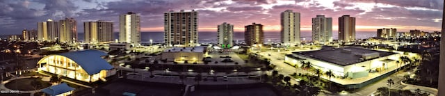 aerial view at dusk featuring a city view